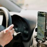 a person using a cell phone while driving a car