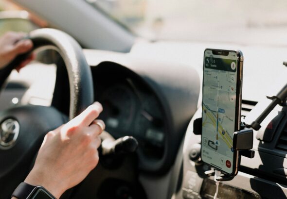 a person using a cell phone while driving a car